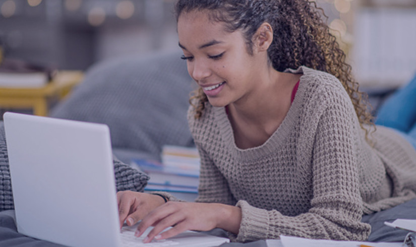 Female student typing question into chat during online session